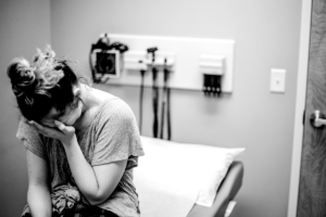 Femme qui pleure dans le bureau du médecin, image en noir et blanc